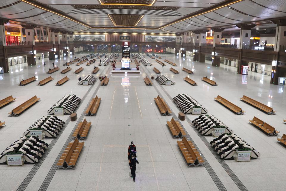 Police officers patrol the empty Xi'an Railway Station