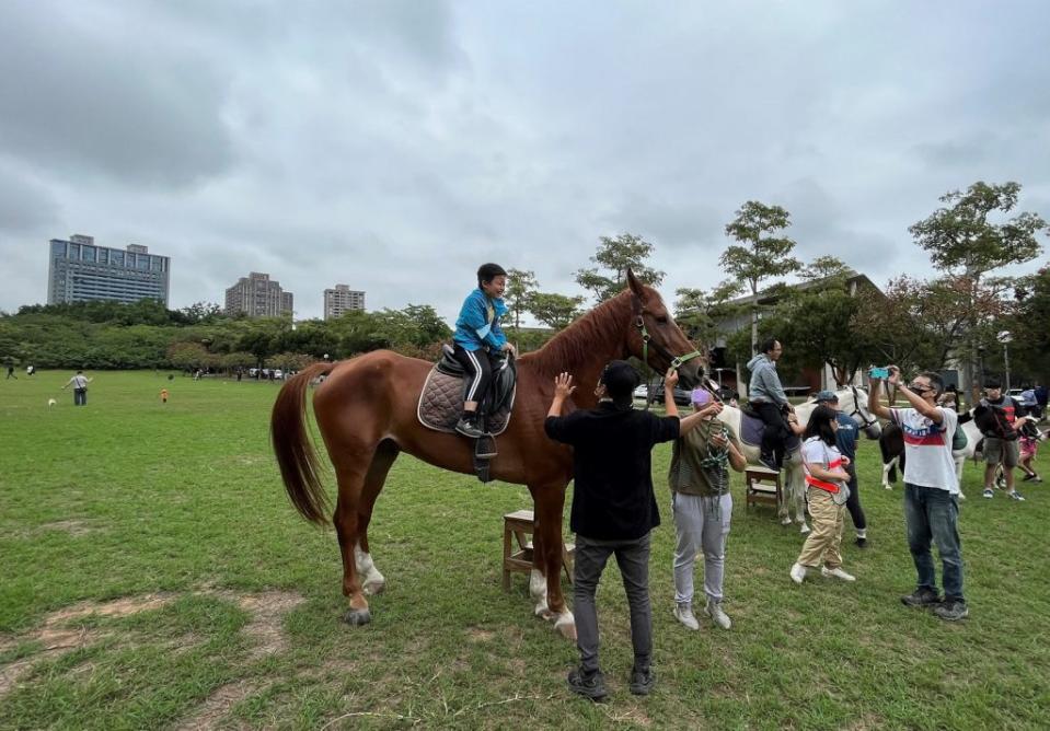 東海大學舉辦馬術體驗營，吸引家長帶著小孩前來騎乘體驗。（記者徐義雄攝）