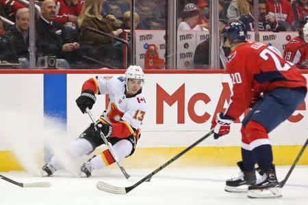 Nov 20, 2017; Washington, DC, USA; Calgary Flames left wing Johnny Gaudreau (13) skates with the puck as Washington Capitals center Lars Eller (20) defends in the first period at Capital One Arena. The Flames won 4-1. Geoff Burke-USA TODAY Sports