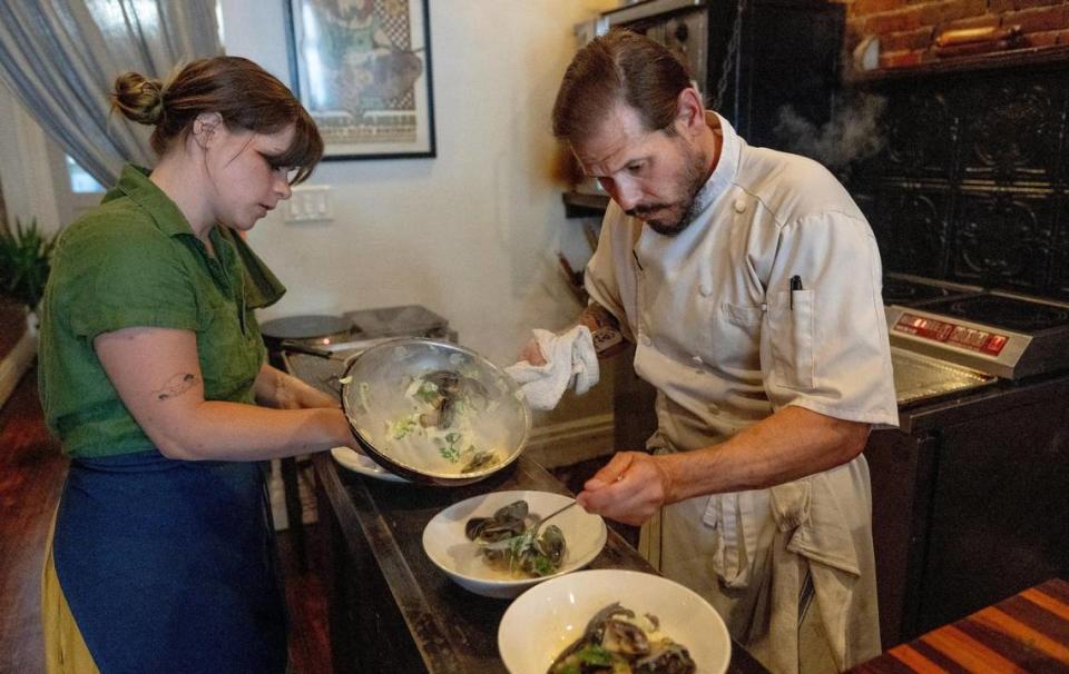 Nick Martinkovich and Molly Diven plate dishes at the restaurant’s narrow pass.