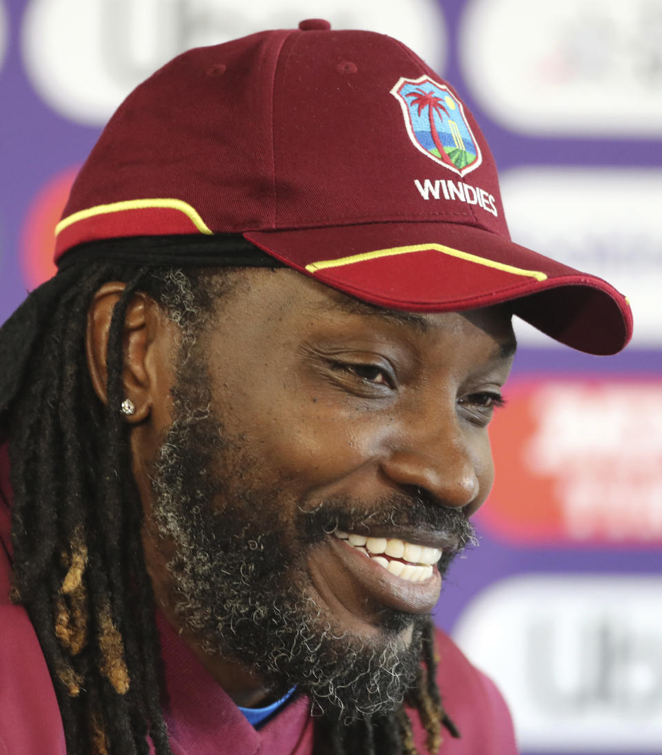 West Indies' Chris Gayle smiles during a press conference after attending a training session ahead of their Cricket World Cup match against India at Old Trafford in Manchester, England, Wednesday, June 26, 2019. (AP Photo/Aijaz Rahi)