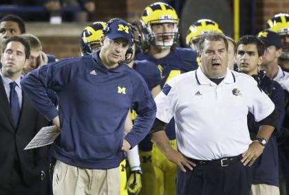 Michigan coaches Doug Nussmeier (L) and Brady Hoke watched the Wolverines fall 26-10 to Utah on Saturday. (AP)