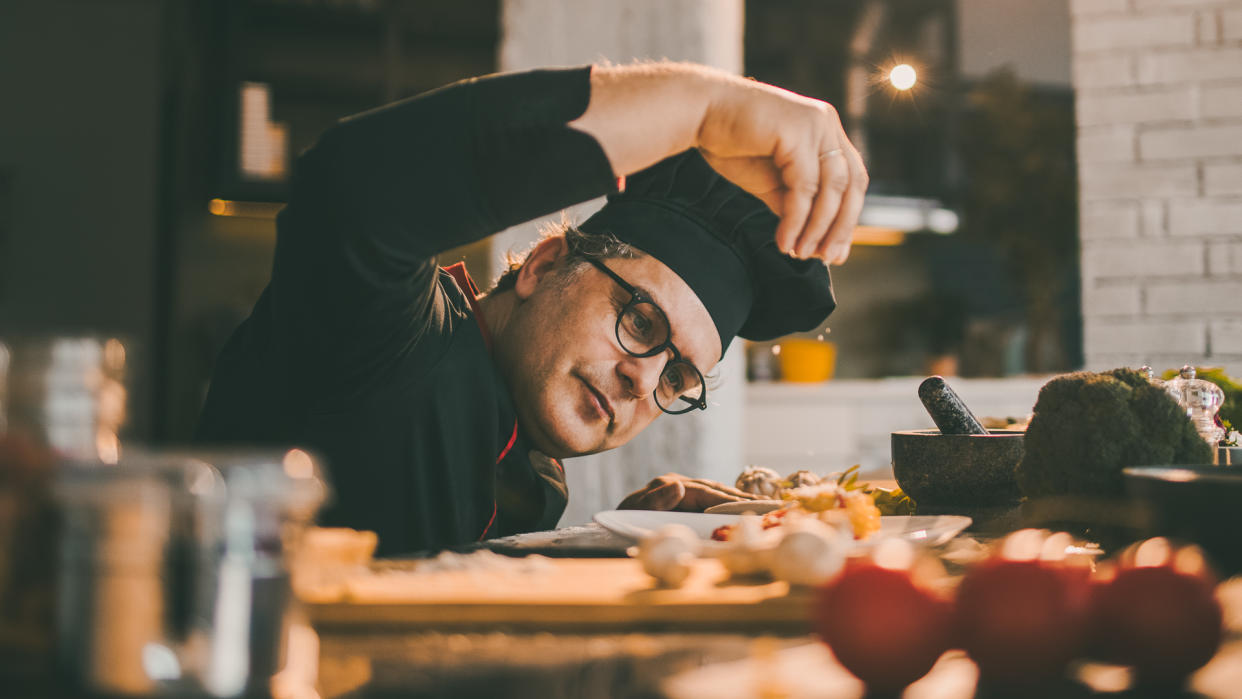 experienced chef adding spices to the meal he is preparing