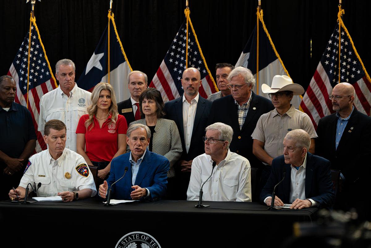 From left, front row: Emergency Management Chief Nim Kidd, Gov. Greg Abbott, Lt. Gov. Dan Patrick and Jim “Mattress Mack” McIngvale hold a press conference at Gallery Furniture in Houston to address the restoration of power in the aftermath of Hurricane Beryl, on Sunday, July 14, 2024.