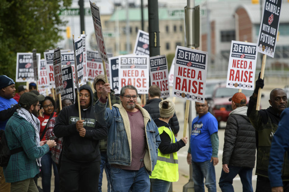 Unionized workers walk the picket line during a strike in front of the MGM Grand Detroit casino, in Detroit, Tuesday, Oct. 17, 2023. (David Guralnick/Detroit News via AP)