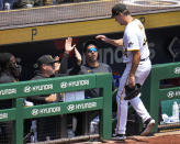 Pittsburgh Pirates starting pitcher Rich Hill, right, is greeted at the dugout steps as he leaves the baseball game during the seventh inning against the St. Louis Cardinals in Pittsburgh, Sunday, June 4, 2023. (AP Photo/Gene J. Puskar)