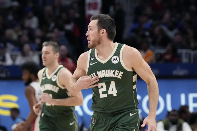Milwaukee Bucks guard Pat Connaughton reacts after a three-point basket during the second half of an NBA basketball game against the Detroit Pistons, Monday, March 27, 2023, in Detroit. (AP Photo/Carlos Osorio)