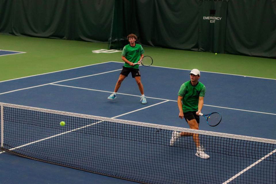 Jacob Hafele and Nathan Mitchell in action on the court.