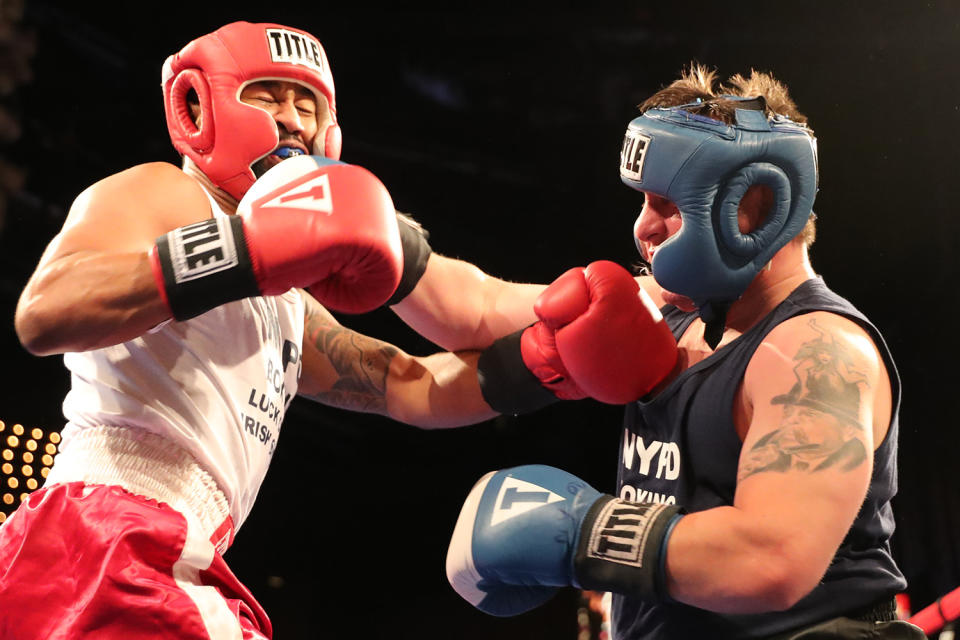 <p>Spiderman and Mike Alba, right mix it up in the ring during the NYPD Boxing Championships at the Theater at Madison Square Garden on June 8, 2017. (Photo: Gordon Donovan/Yahoo News) </p>