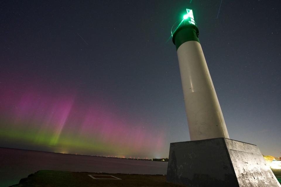 The Northern lights or aurora borealis illuminate the night sky on Sunday in Grand Bend, Ontario, Canada during a geomagnetic storm. The most powerful solar storm in more than two decades struck Earth on Friday, triggering spectacular celestial light shows in skies from Tasmania to Britain, and threatening possible disruptions to satellites and power grids as it persisted into the weekend. Auroras are often observed in Canada's northern regions, but rarely in southern Ontario.