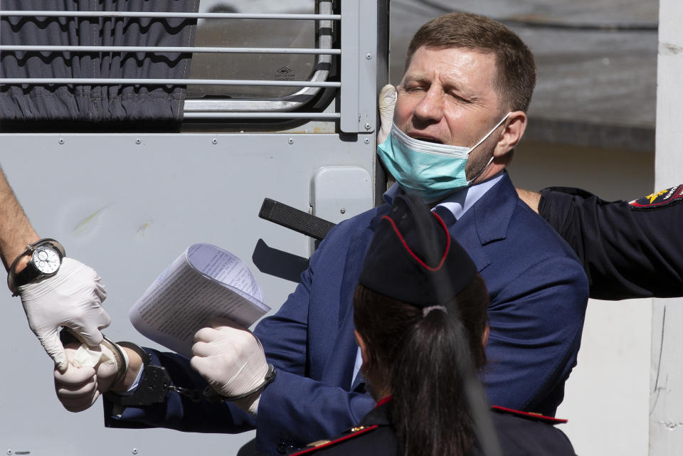 A governor of the Khabarovsk region along the border with China, Sergei Furgal is escorted from a court room in Moscow, Russia, Friday, July 10, 2020. A provincial governor in Russia's far east has been arrested on charges of involvement in multiple murders and was flown to Moscow. The court ordered Frugal to be jailed for two months as the investigation continues. (AP Photo/Alexander Zemlianichenko)