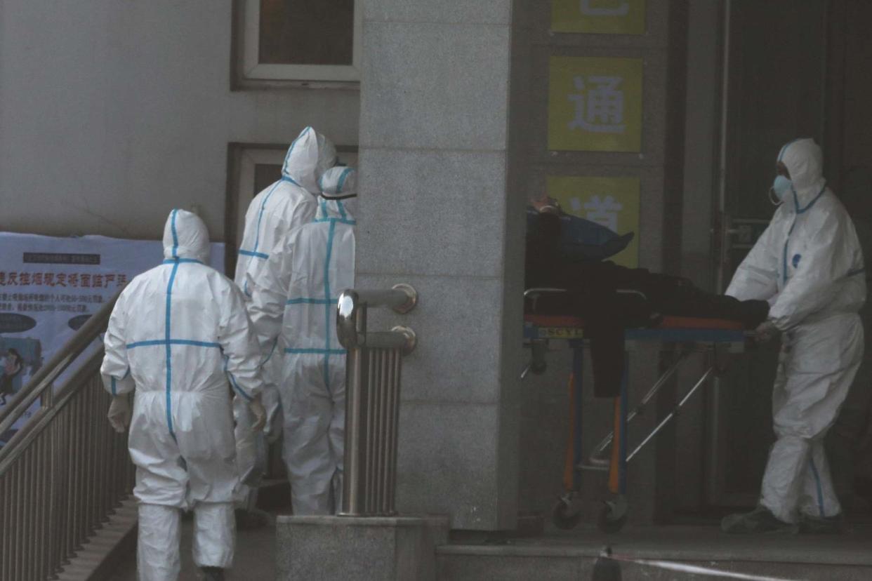 Medical staff transfer a patient from an ambulance at the Jinyintan hospital: REUTERS