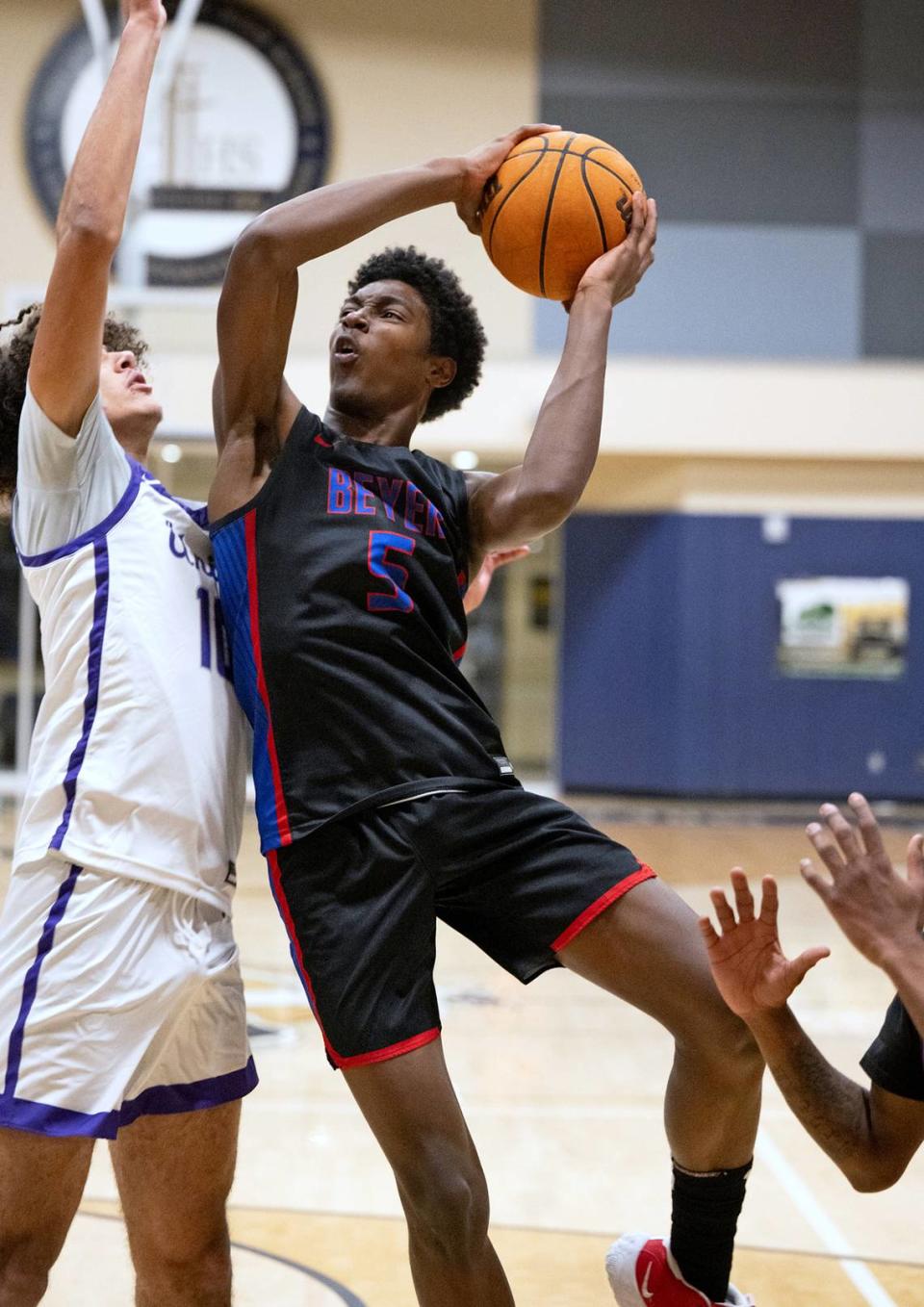 Beyer’s Charles Booker drives to the basket on Washington Union’s Damien Burks advances the ball up the court during the Mark Gallo Invitational Basketball Tournament game with Washington Union at Central Catholic High School in Modesto, Calif., Friday, Dec. 8, 2023.