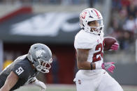 Stanford running back Austin Jones, right, carries the ball while Washington State linebacker Francisco Mauigoa pursues during the first half of an NCAA college football game, Saturday, Oct. 16, 2021, in Pullman, Wash. (AP Photo/Young Kwak)