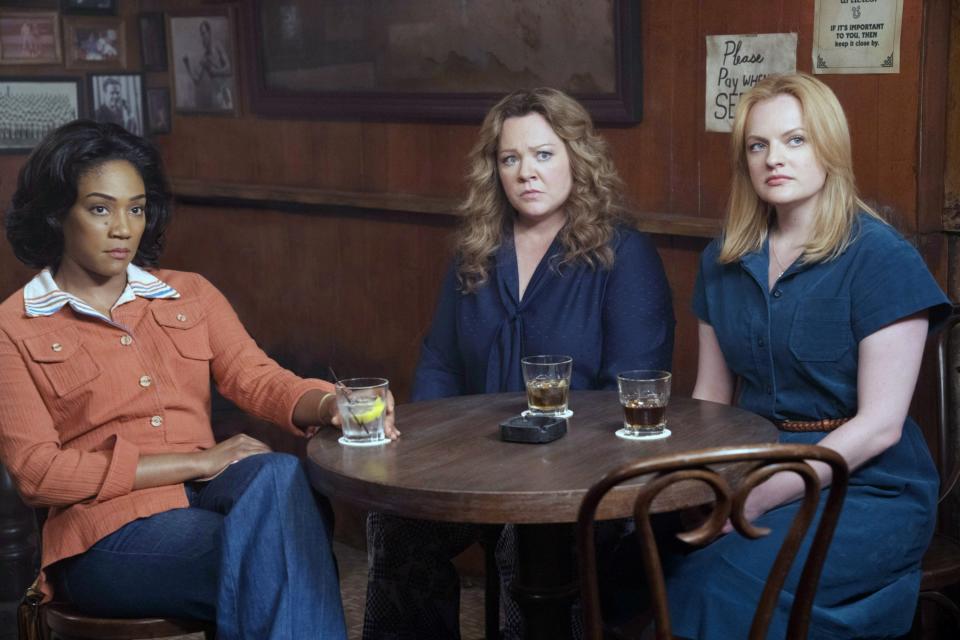 three women at a table facing the same way