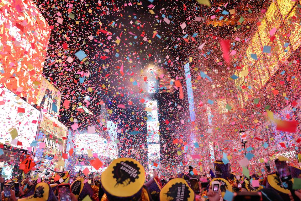 Onlookers watch as confetti fills the air to mark the beginning of the new year, in Times Square, New York City, on January 1, 2023.