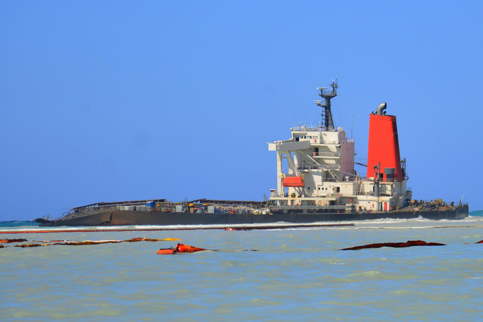 FILE — In this Sunday, Aug. 16 file photo the Japanese MV Wakashio, a bulk carrier ship that recently ran aground off the southeast coast of Mauritius, can be seen from the coast of Mauritius. The oil spill disaster turned deadly this week when a tugboat leaving the shipwreck collided with a barge and sank, killing at least three sailors, police said Tuesday Sept. 1, 2020. (AP Photo/ Sumeet Mudhoo-L'express Maurice/File)