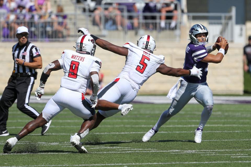 Texas Tech defensive end Myles Cole (5) reaches for Kansas State quarterback Adrian Martinez during the Red Raiders' 37-28 loss last season in Manhattan, Kansas. Cole made two tackles for loss during Texas Tech's Texas Bowl upset of Mississippi, a performance that has Tech coach Joey McGuire encouraged about Cole's potential for 2023.