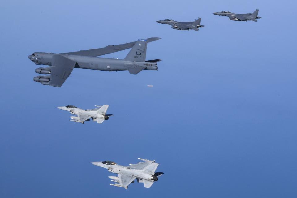 In this photo provided by South Korea Defense Ministry, a U.S. Air Force B-52H Stratofortress aircraft, center, flies in formation with South Korea's Air Force KF-16 fighters, bottom, and South Korea's Air Force F-15K fighters over the western sea of Korean peninsula during a joint air drill in South Korea, Monday, March 6, 2023. (South Korea Defense Ministry via AP)