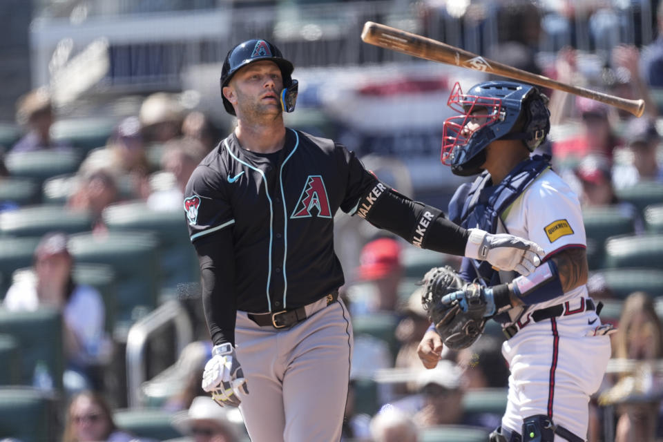 Arizona Diamondbacks' Christian Walker tosses his bat after striking out in the sixth inning of a baseball game against the Atlanta Braves Sunday, April 7, 2024, in Atlanta. (AP Photo/John Bazemore)