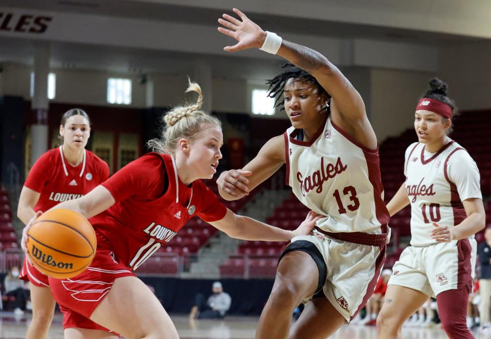 Louisville guard Hailey Van Lith (10) drives against the defense of Boston College forward Taylor Soule (13) during the first half of an NCAA college basketball game, Sunday, Jan. 16, 2022, in Boston. (AP Photo/Mary Schwalm)