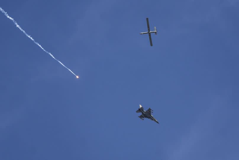 An Israeli fighter jet and a drone seen from Rafah, Gaza Strip.