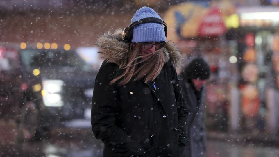 A morning commuter makes her way through wind and snow in New York on Tuesday. - Brendan McDermid/Reuters