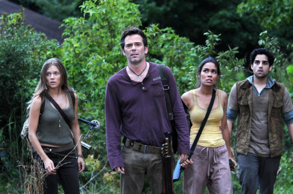 FILE - This file image released by NBC shows, from left, Tracy Spiridakos as Charlie Matheson, Billy Burke as Miles Matheson, Daniella Alonso as Nora, and Paras Patel as Albert, in a scene from "Revolution." Violent dramas on the broadcast networks carry milder parental cautions than cable shows but can equal them in graphic gore, a failure of the TV ratings system, according to a Parents Television Council study released Monday, Dec. 9, 2013. (AP Photo/NBC, Brownie Harris, File)