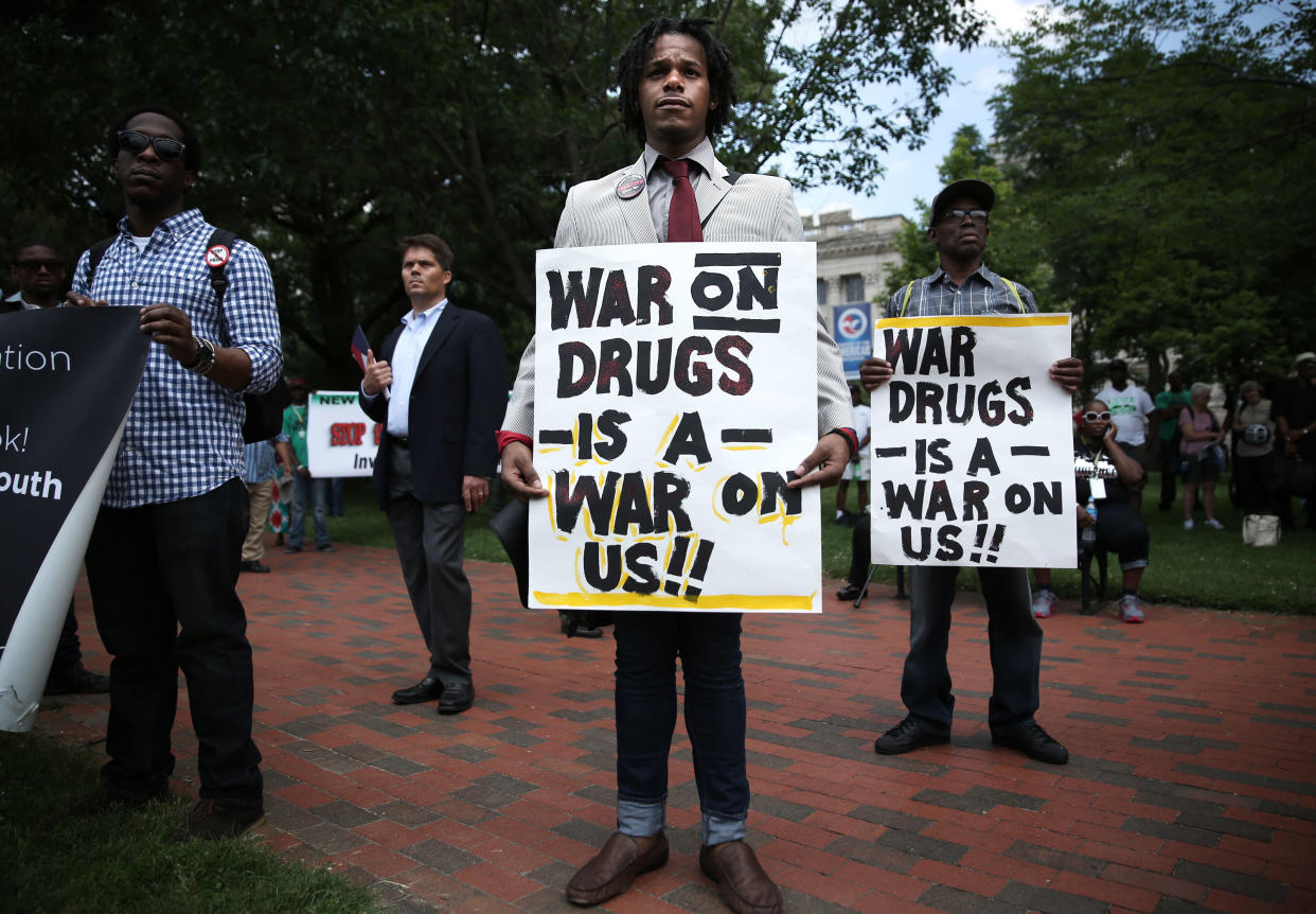 Demonstrators hold signs during a rally.