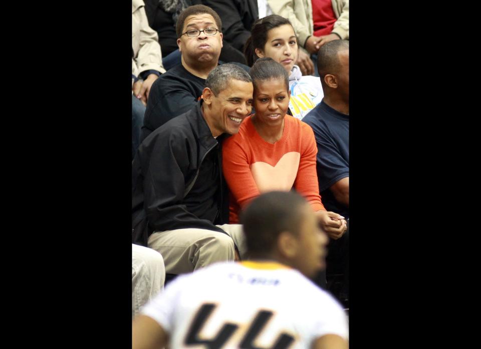 BALTIMORE, MD - NOVEMBER 26:  U.S. President Barack Obama and first lady Michelle Obama watch the Oregon State Beavers play the Towson Tigers at the Towson Center on November 26, 2011 in Baltimore, Maryland. The first lady's brother, Craig Robinson, is head coach of the Oregon State team.  (Photo by Martin H. Simon-Pool/Getty Images)