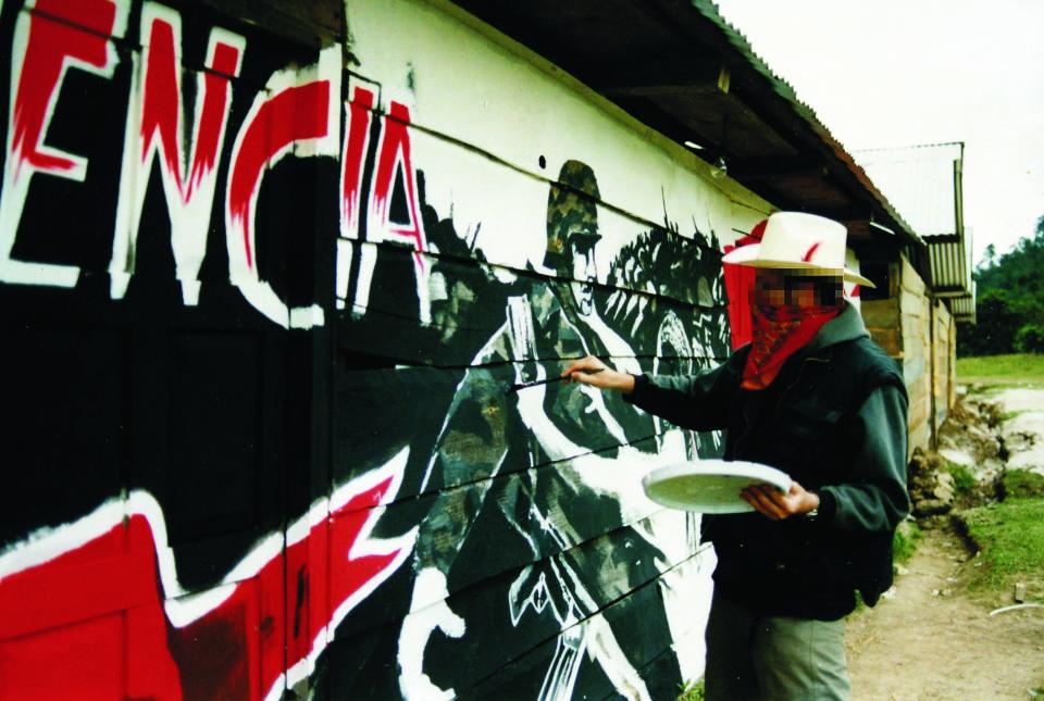 This is the first ever confirmed picture of secretive graffiti artist Banksy - taken when he was an amateur footballer on tour playing against freedom fighters.       Before he shot to fame as Britain's most successful artist, secretive Banksy used to be a goalkeeper for Bristol-based football club Easton Cowboys and Cowgirls, and joined them on their 2001 tour of Mexico. In a break between games with Zapatista freedom fighters, Banksy - who famously never reveals his face to the public - painted a mural depicting their struggle for independence. Club secretary Will Simpson said the world-famous artist began turning up to football sessions in the 1990s, before he became the figurehead for street art.