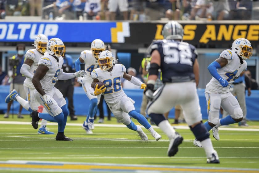 Cornerback (26) Asante Samuel, Jr. of the Los Angeles Chargers intercepts a pass and runs against the Dallas Cowboys in an NFL football game, Sunday, Sept. 19, 2021, in Inglewood, Calif. The Cowboys defeated the Chargers 20-17. (AP Photo/Jeff Lewis)