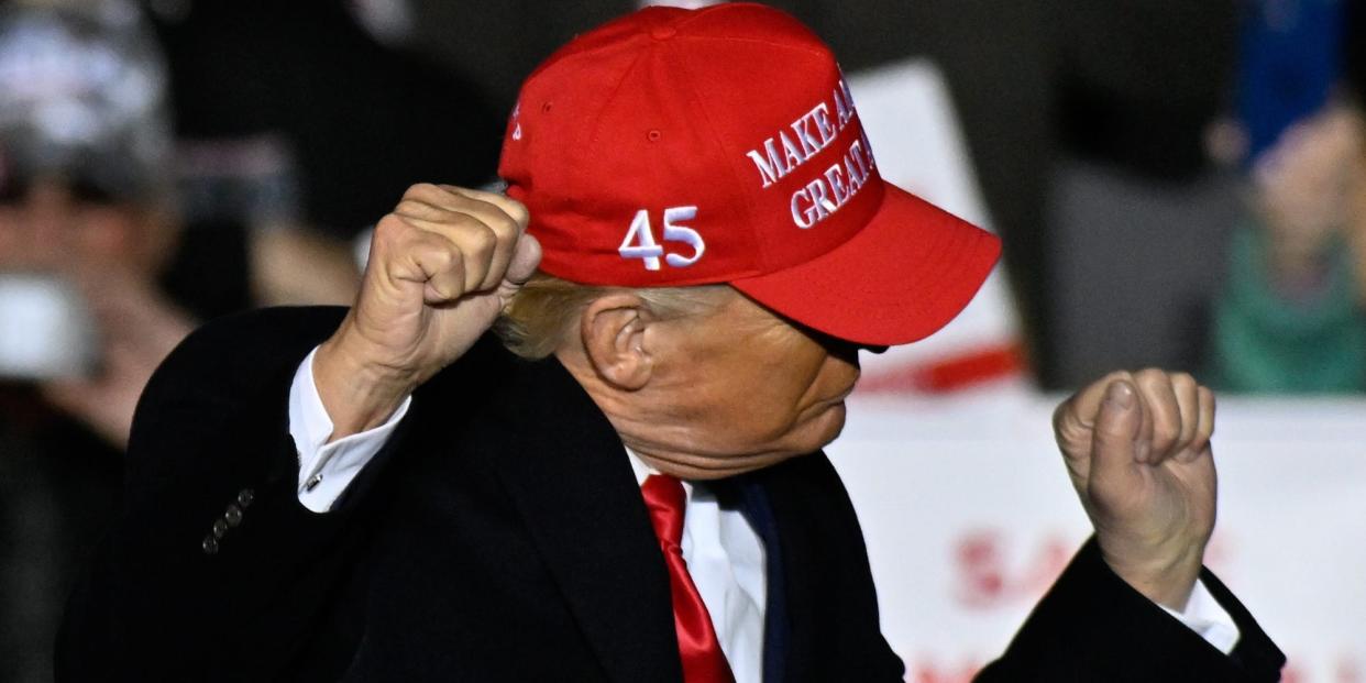 Former President Donald Trump makes dancing motions at a rally in Commerce, GA on March, 26, 2022.