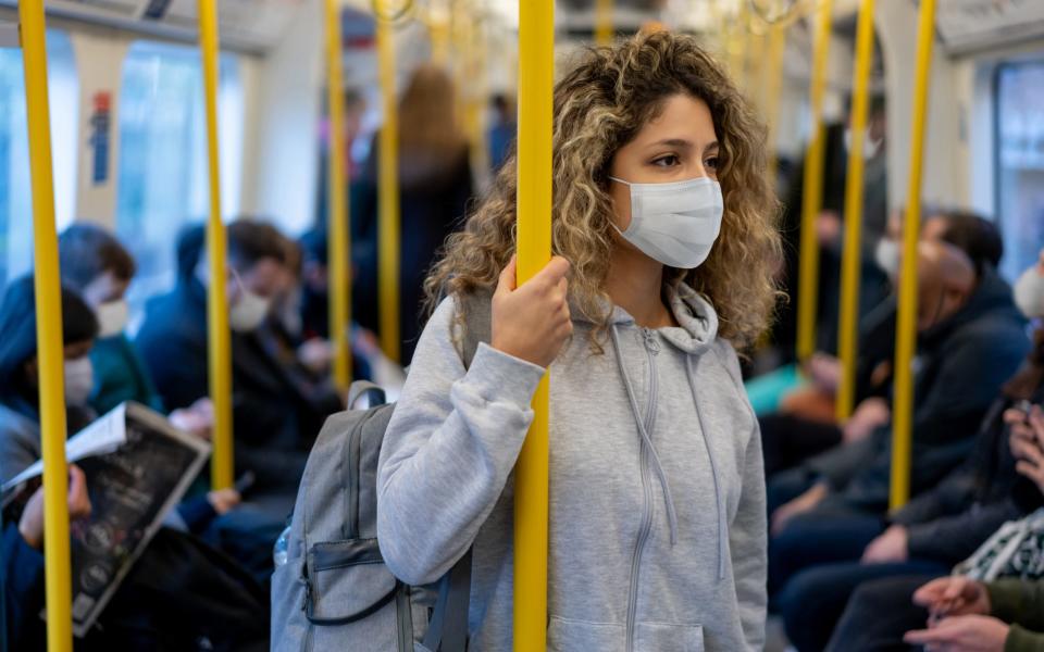 Woman on the metro wearing a face mask