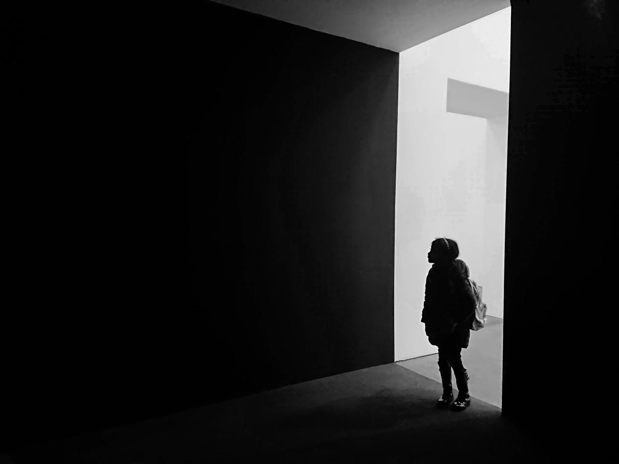 Silhouette of young girl in doorway
