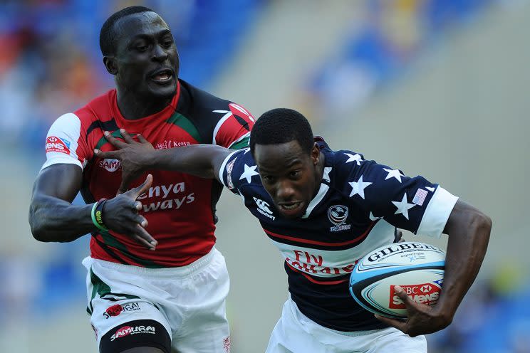 GOLD COAST, AUSTRALIA - OCTOBER 12: Carlin Isles of the United States fends off the defence to score a try during the Gold Coast Sevens round one match between Kenya and the United States at Skilled Stadium on October 12, 2013 on the Gold Coast, Australia. (Photo by Matt Roberts/Getty Images)