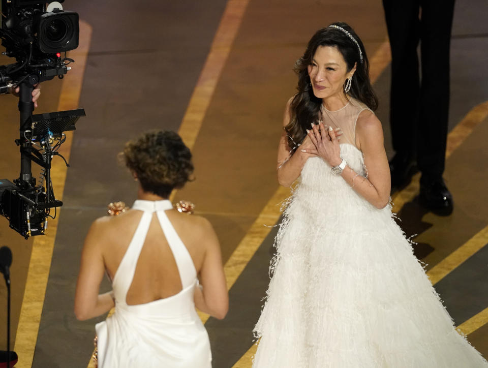 Halle Berry, left, presents Michelle Yeoh with the award for best performance by an actress in a leading role for "Everything Everywhere All at Once" at the Oscars on Sunday, March 12, 2023, at the Dolby Theatre in Los Angeles. (AP Photo/Chris Pizzello)