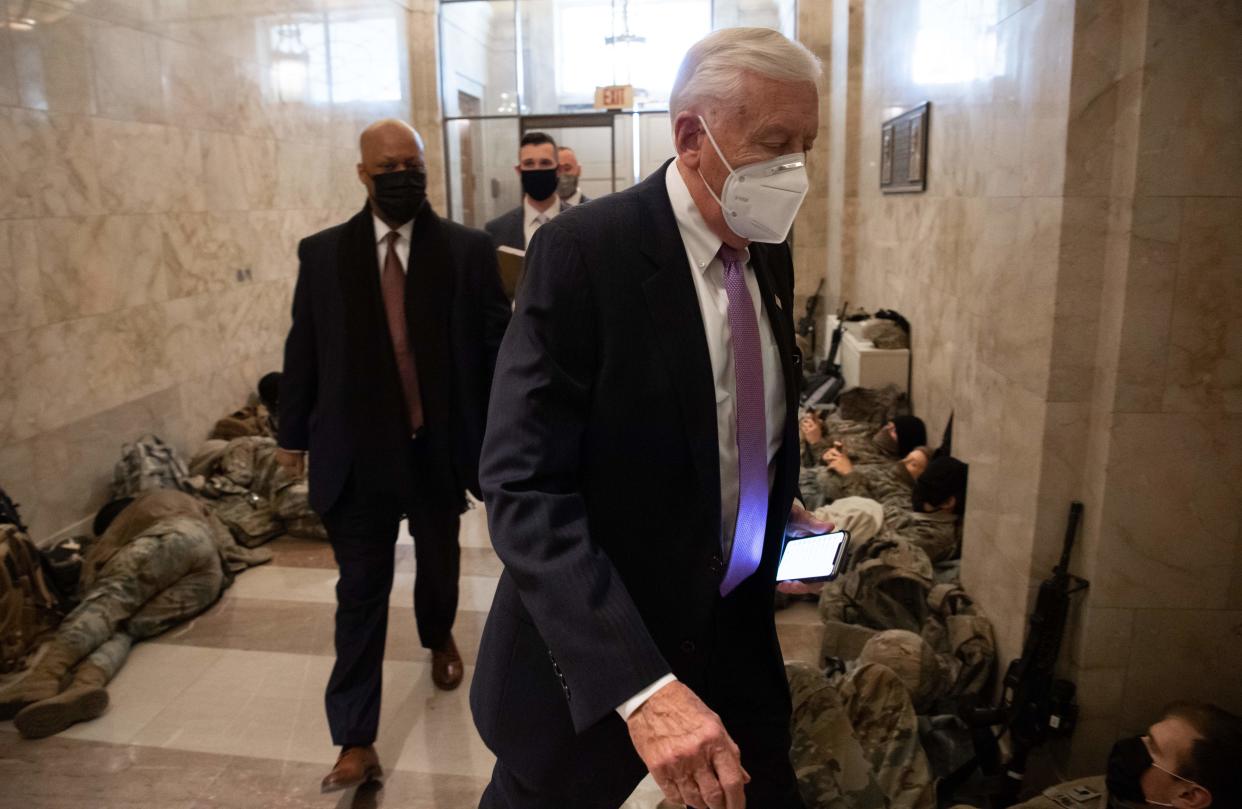 House Majority Leader Steny Hoyer, Democrat of Maryland, walks past members of the National Guard as he arrives at the Capitol on 13 January, 2021 (AFP via Getty Images)