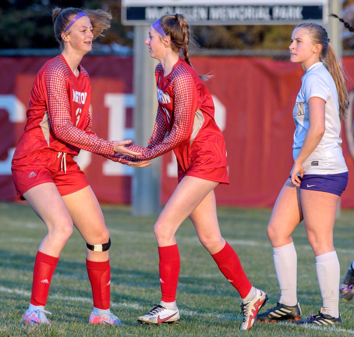 Morton's Addie Dea, left, congratulates teammate Edie Hart on a goal in the first half of their soccer match Tuesday, March 28, 2023 at McClallen Park in Morton. The Potters defeated the Little Giants 9-0.