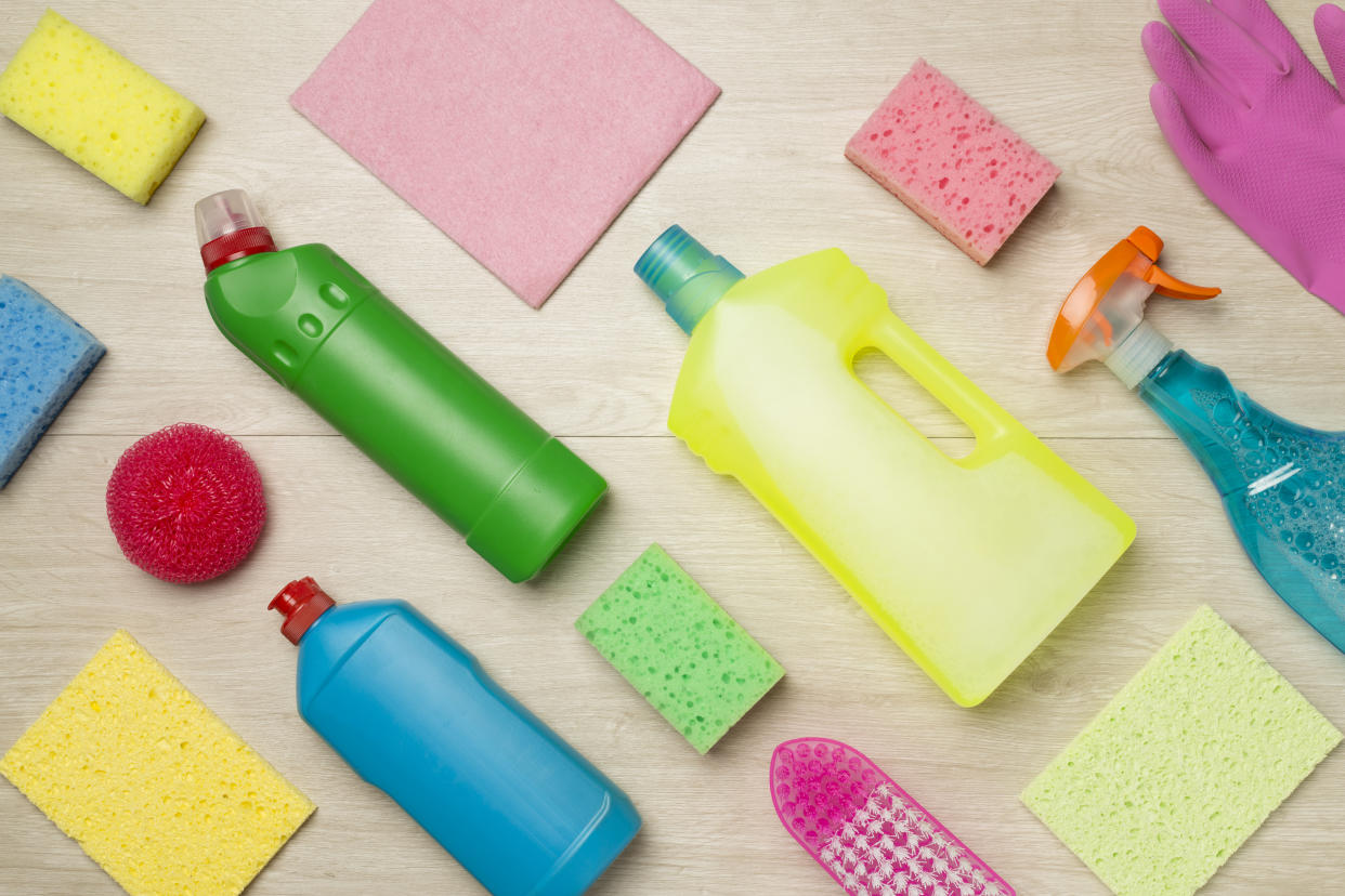 Many different house cleaning products on wooden background, top view.