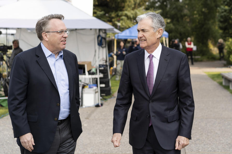 FTSE 100 FILE - In this Aug. 24, 2018, file photo John Williams, left, President and CEO of the Federal Reserve Bank of New York, left, and Jerome Powell, Chairman of the Board of Governors of the Federal Reserve System, right, walk together after Powell's speech at the Jackson Hole Economic Policy Symposium in Jackson Hole, Wyo. Williams said said Thursday, Jan. 9, 2020, that the Fed needs to re-orient its policies toward fighting inflation that is too low, rather than its historic focus on keeping inflation from getting too high. (AP Photo/Jonathan Crosby, File)