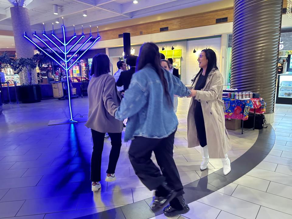 Members of the public stopped the enjoy the festival honoring the sixth day of Hanukkah held at Westgate Mall Tuesday night.