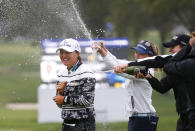 Jin Young Ko, left, of South Korea, is sprayed by Brooke Henderson and Gabby Lopez after winning the Cognizant Founders Cup, Sunday, Oct.10, 2021, in West Caldwell, N.J. (AP Photo/Noah K. Murray)