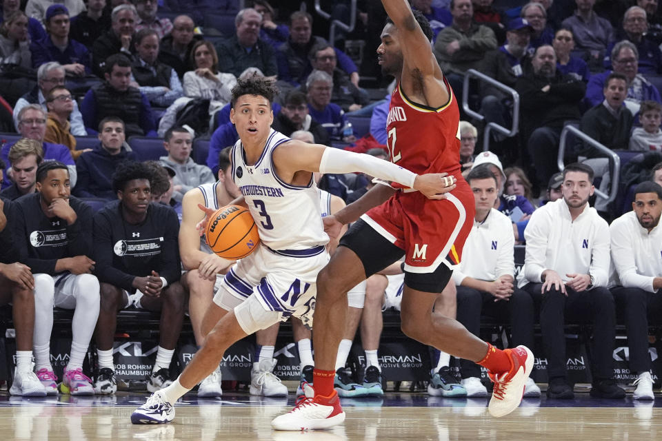 Northwestern guard Ty Berry, left, drives as Maryland forward Jordan Geronimo defends during the second half of an NCAA college basketball game in Evanston, Ill., Wednesday, Jan. 17, 2024. (AP Photo/Nam Y. Huh)