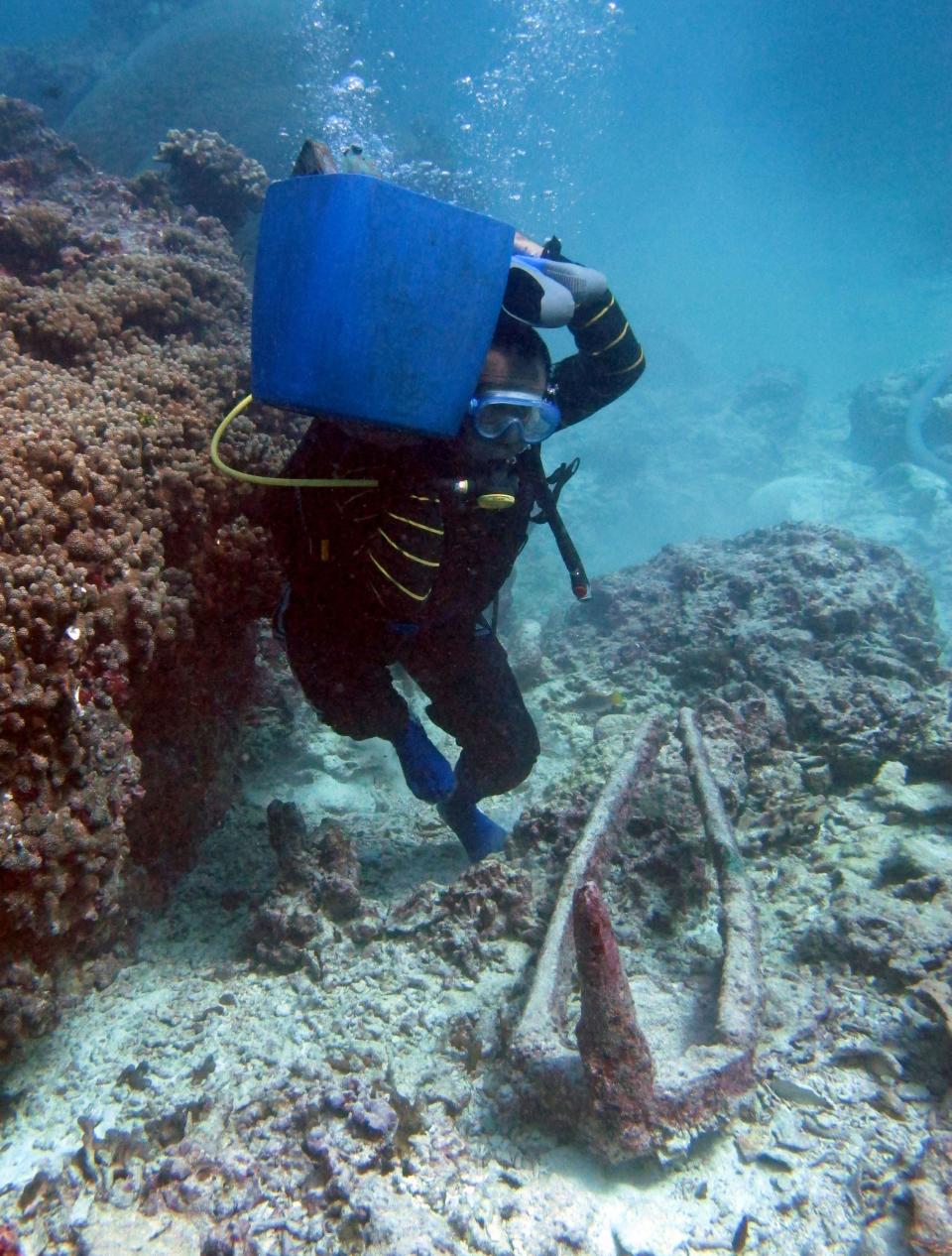 A scuba diver at a shipwreck in Mentawai Islands, Indonesia.