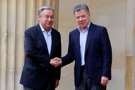 Colombia's President Juan Manuel Santos and U.N. Secretary General Antonio Guterres shake hands outside the presidential palace in Bogota, Colombia January 13, 2018. REUTERS/Jaime Saldarriaga