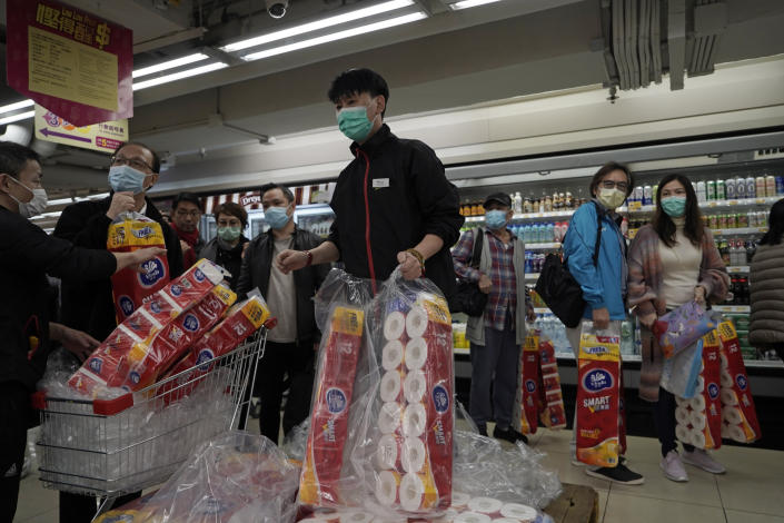 Customers queue to buy supplies of toilet paper in a supermarket in Hong Kong, Feb. 14, 2020. (AP Photo/Kin Cheung)