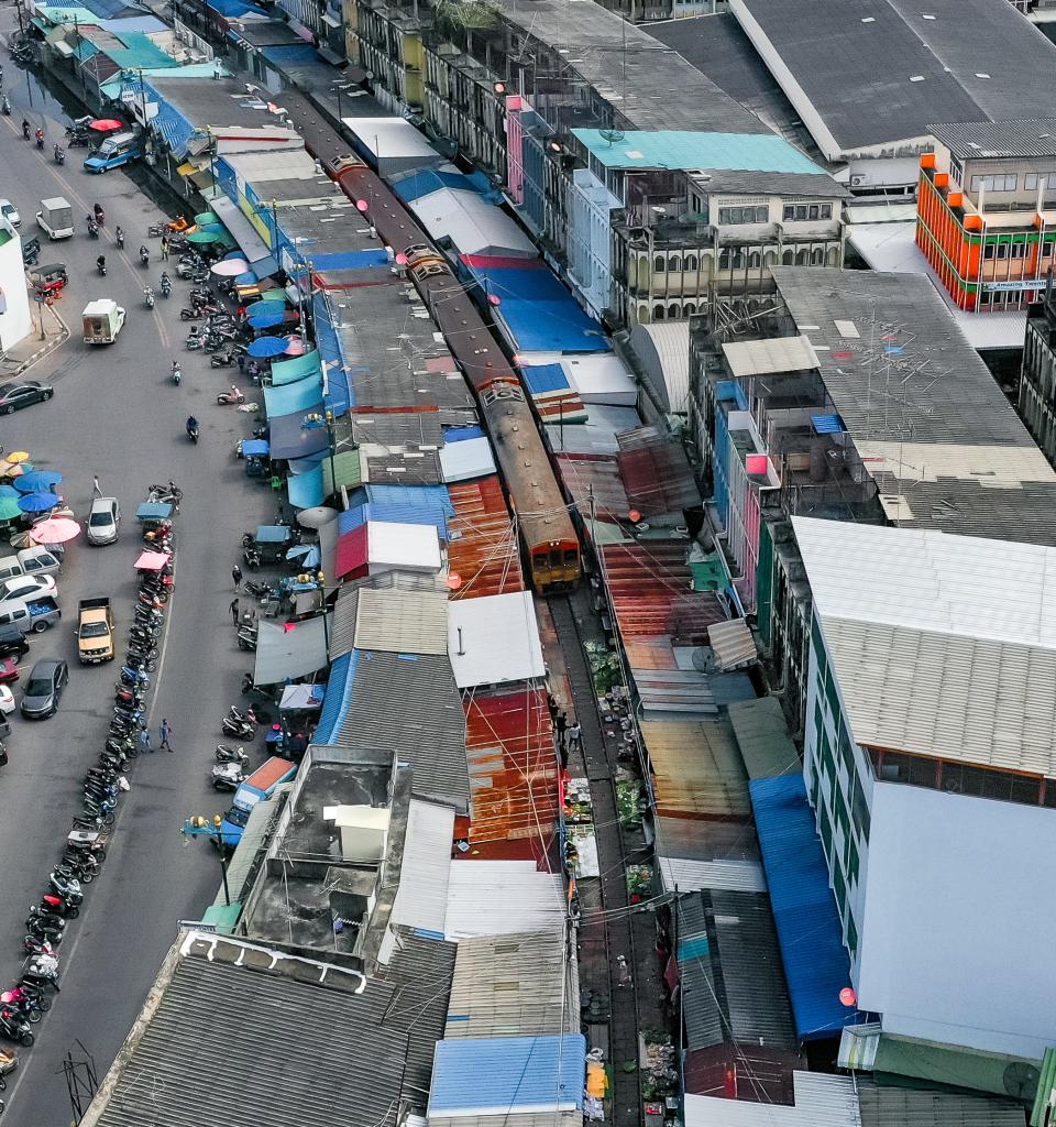 A picture of the market with a train passing through.