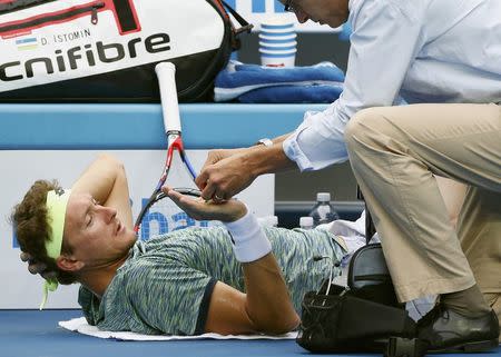 Tennis - Australian Open - Melbourne Park, Melbourne, Australia - 23/1/17 Uzbekistan's Denis Istomin receives medical attention during his Men's singles fourth round match against Bulgaria's Grigor Dimitrov. REUTERS/Issei Kato