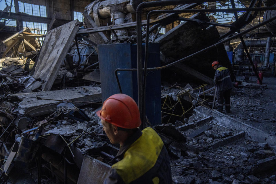 Workers walk among debris in a damaged DTEK thermal power plant after a Russian attack in Ukraine, Thursday, May 2, 2024. Ukrainian energy workers are struggling to repair the damage from intensifying airstrikes aimed at pulverizing Ukraine's energy grid, hobbling the economy and sapping the public's morale. (AP Photo/Francisco Seco)